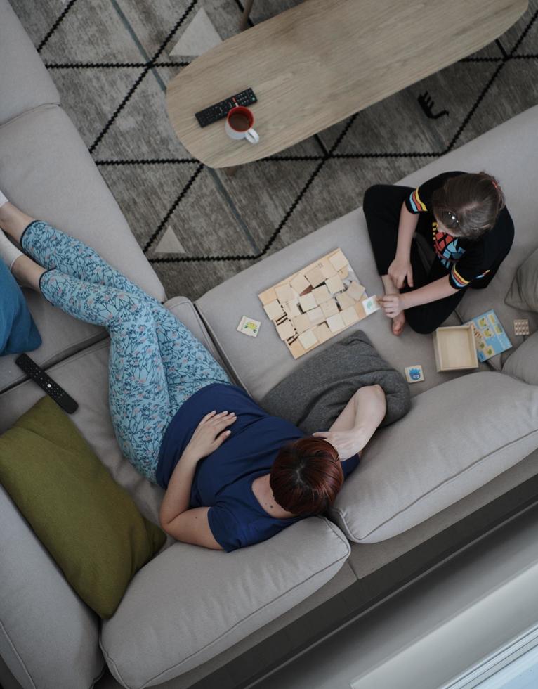 mother and daughter at home playing memory game photo