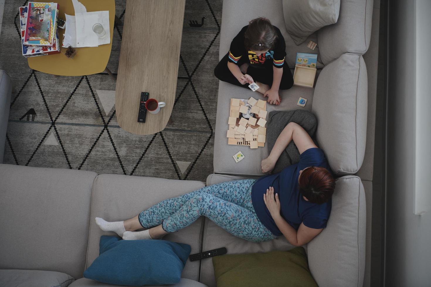 mother and daughter at home playing memory game photo