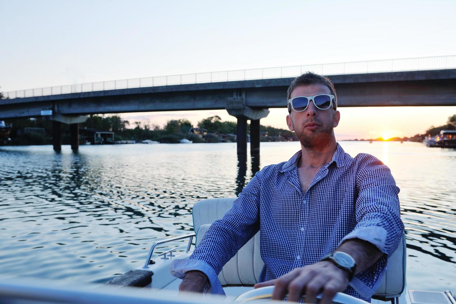 portrait of happy young man on boat photo