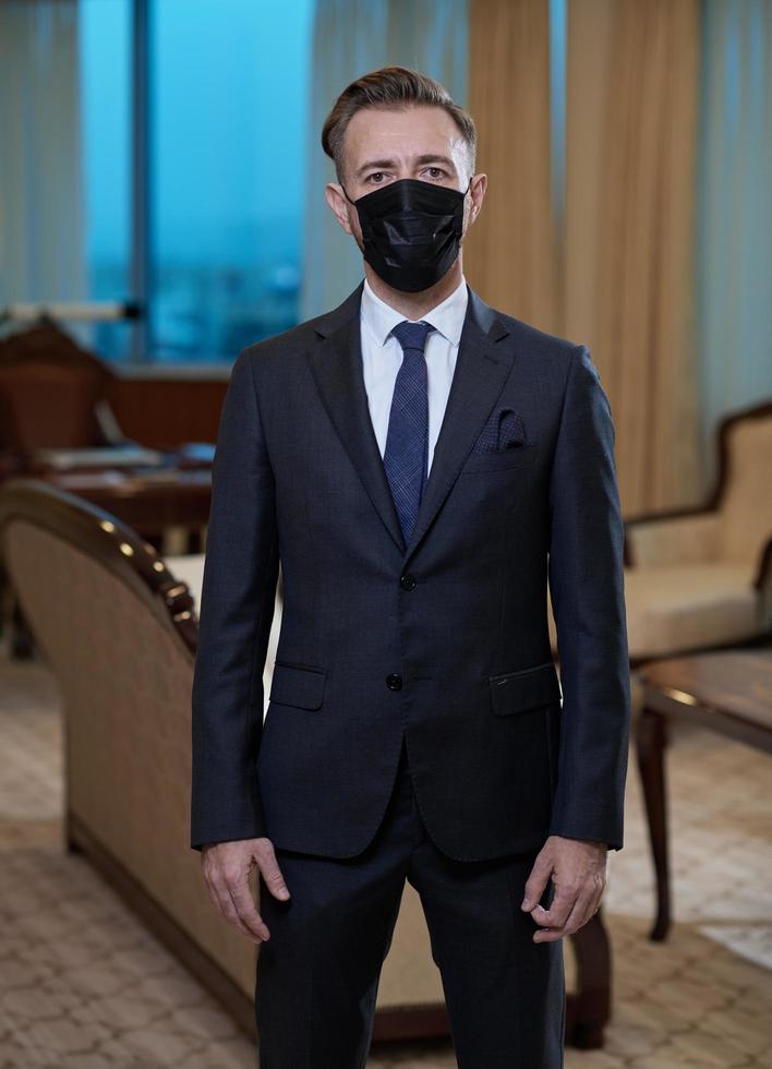 business man wearing protective face mask at office photo