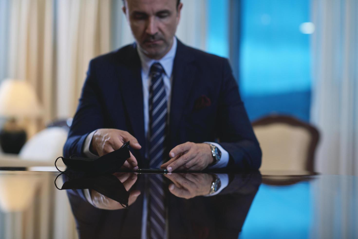 business man using smart phone at luxury office photo