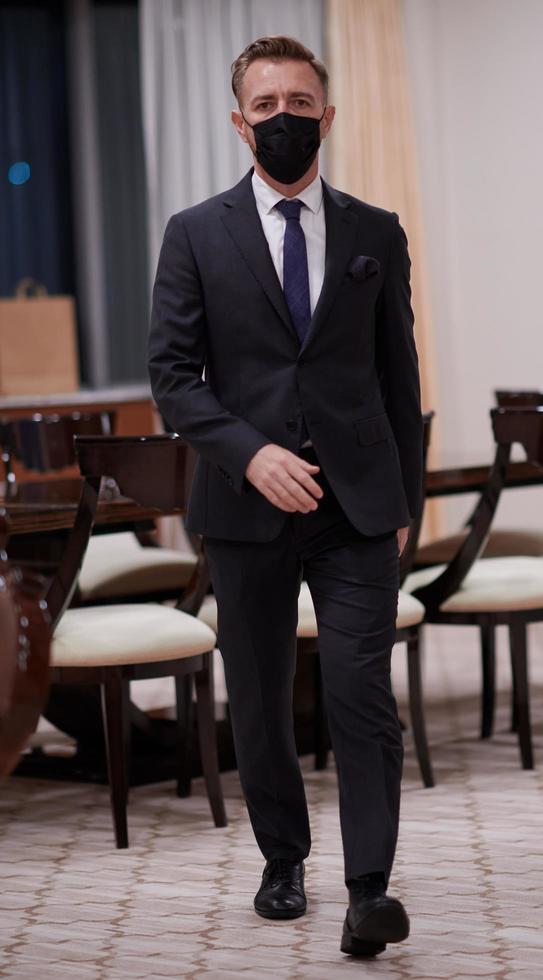 business man wearing protective face mask at office photo