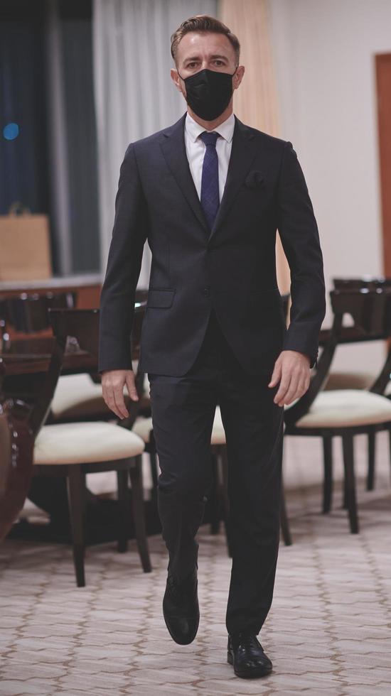 business man wearing protective face mask at office photo