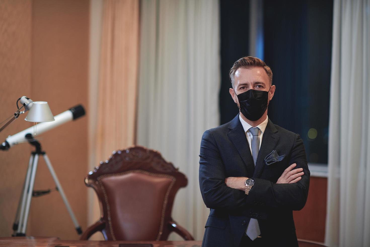 business man wearing protective face mask at office photo