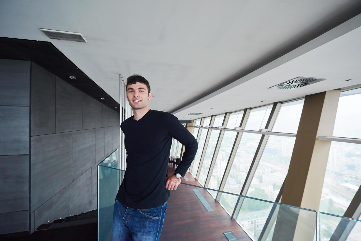 young successful man in penthouse apartment photo