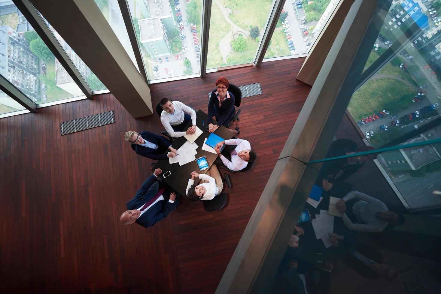 top view of business people group throwing dociments in air photo