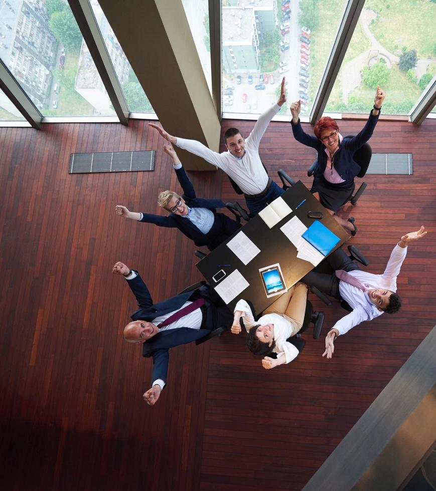 top view of business people group throwing dociments in air photo