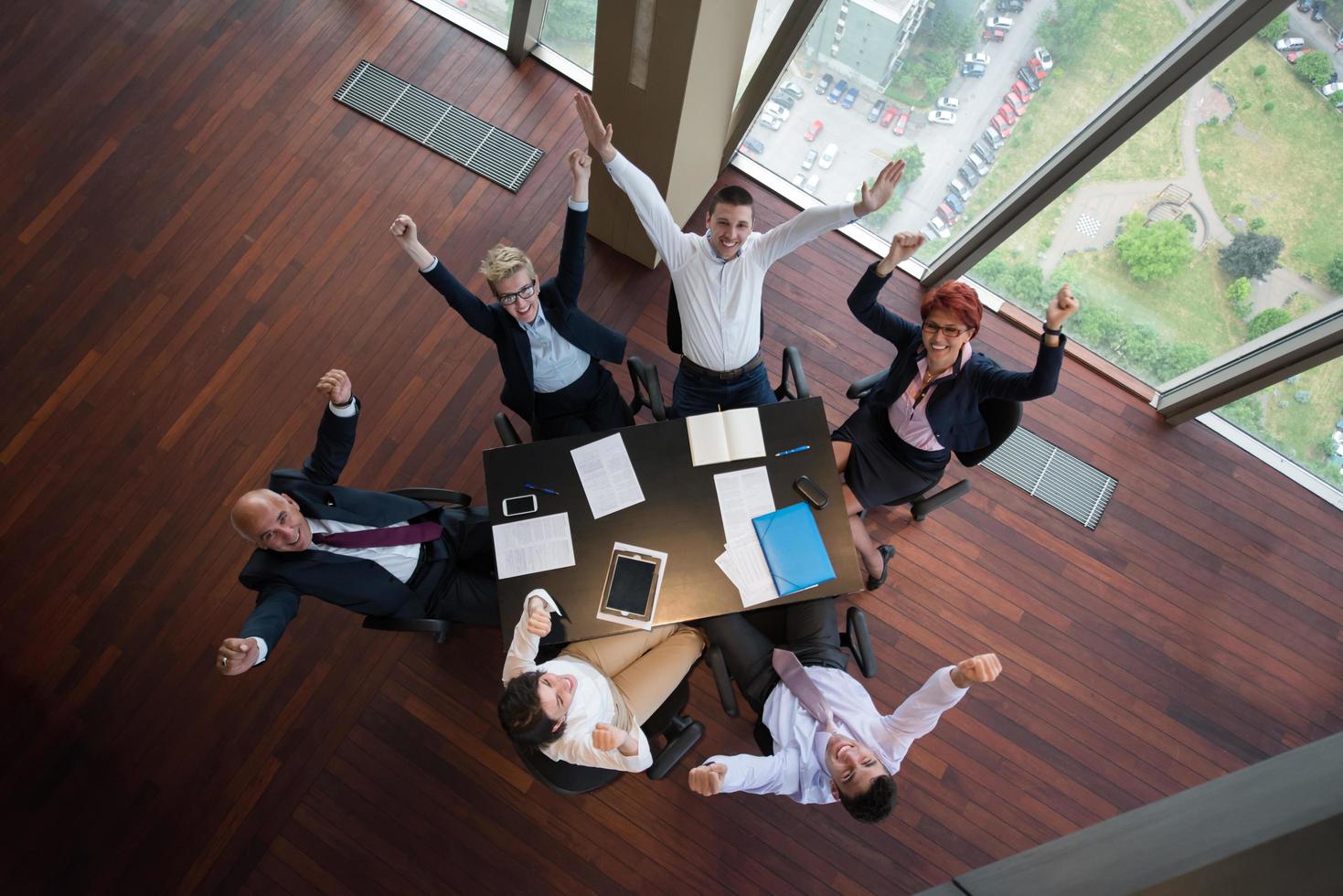 happy business people group on meeting at modern office photo