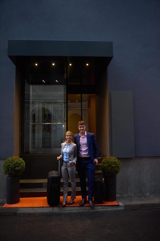 business people couple entering  hotel photo