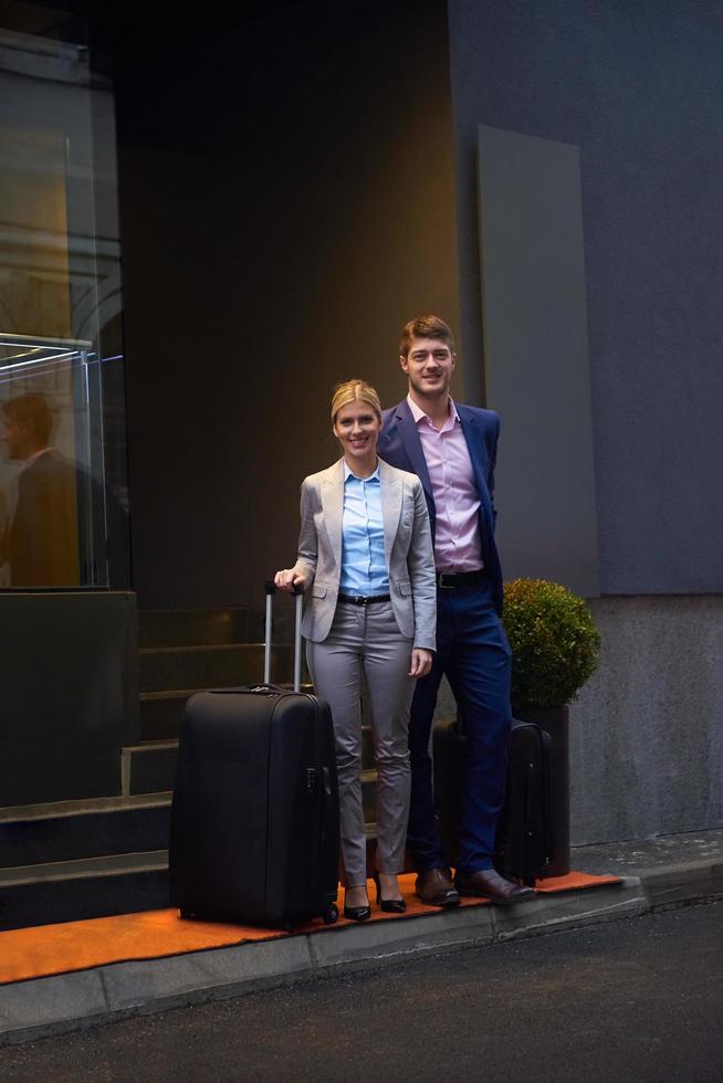 business people couple entering  hotel photo