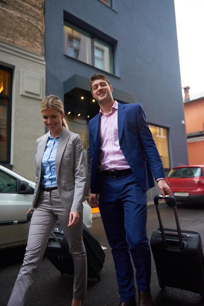 business people couple entering  hotel photo