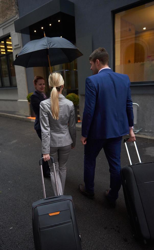business people couple entering  hotel photo