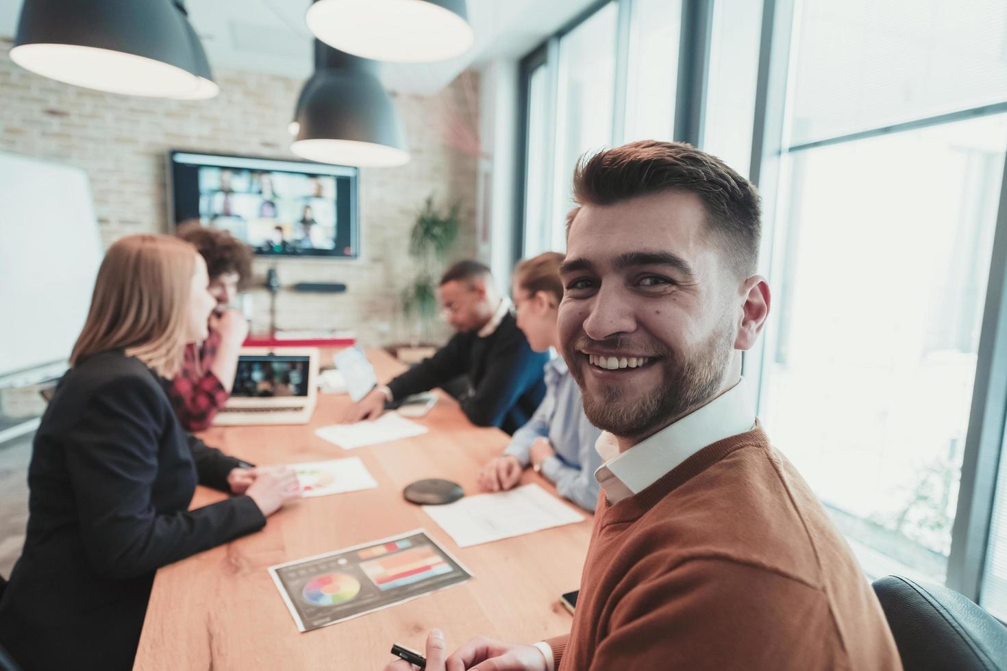 Successful team. Group of young multi-ethnic business people working and communicating together in creative office. Selective focus photo