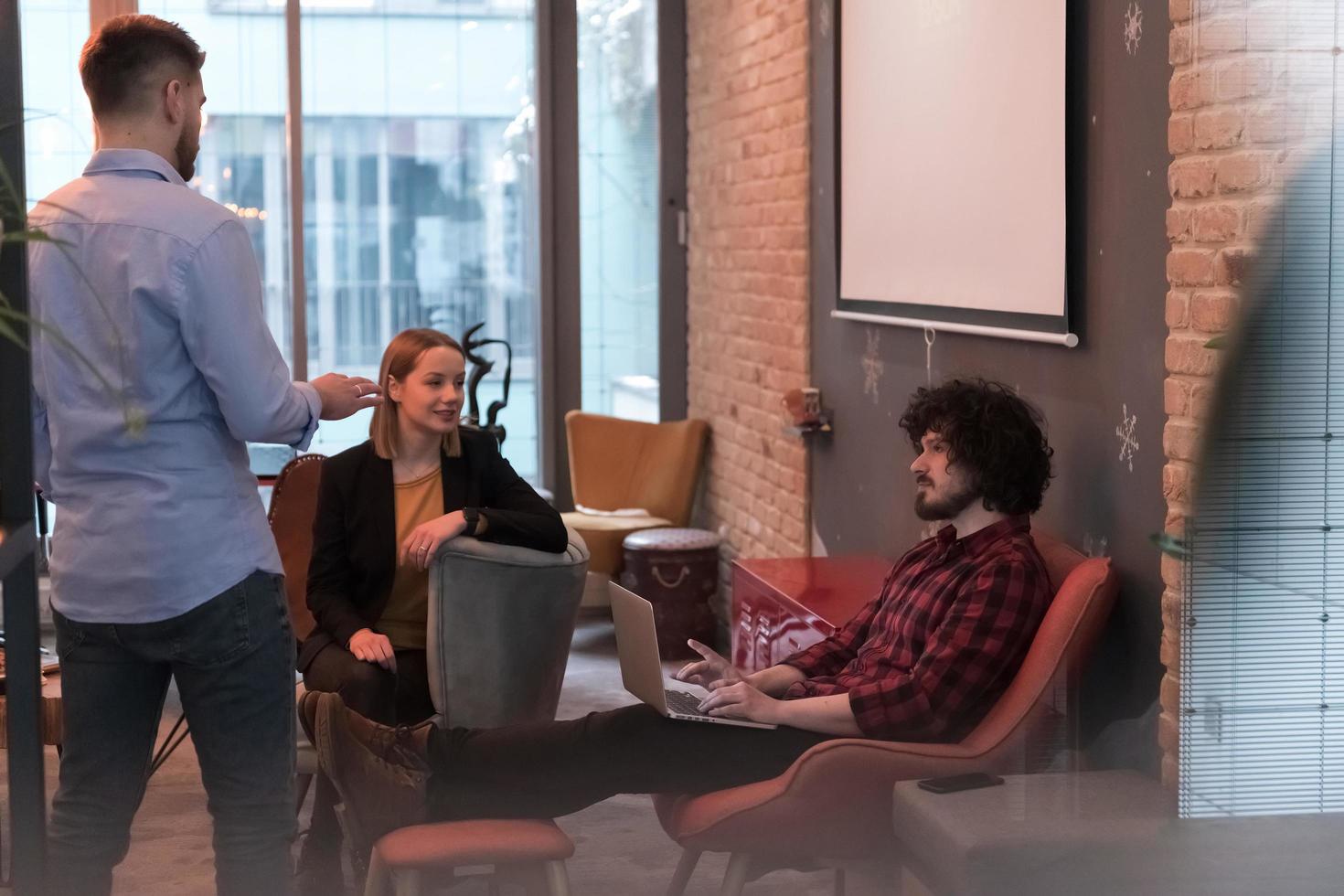 Successful team. Group of young business people working and communicating together in creative office. Selective focus photo