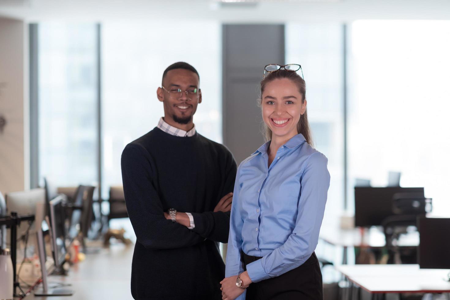 Two happy diverse professional executive business team people woman and African American man looking at camera standing in office lobby hall. Multicultural company managers team portrait. photo