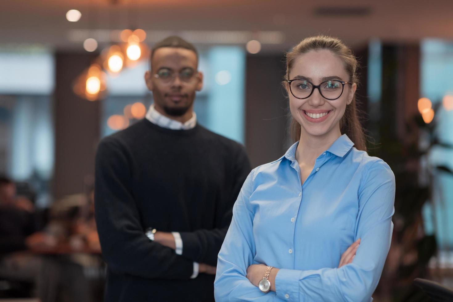 Two happy diverse professional executive business team people woman and African American man looking at camera standing in office lobby hall. Multicultural company managers team portrait. photo