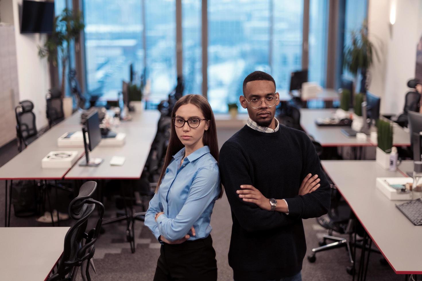 Two happy diverse professional executive business team people woman and African American man looking at camera standing in office lobby hall. Multicultural company managers team portrait. photo