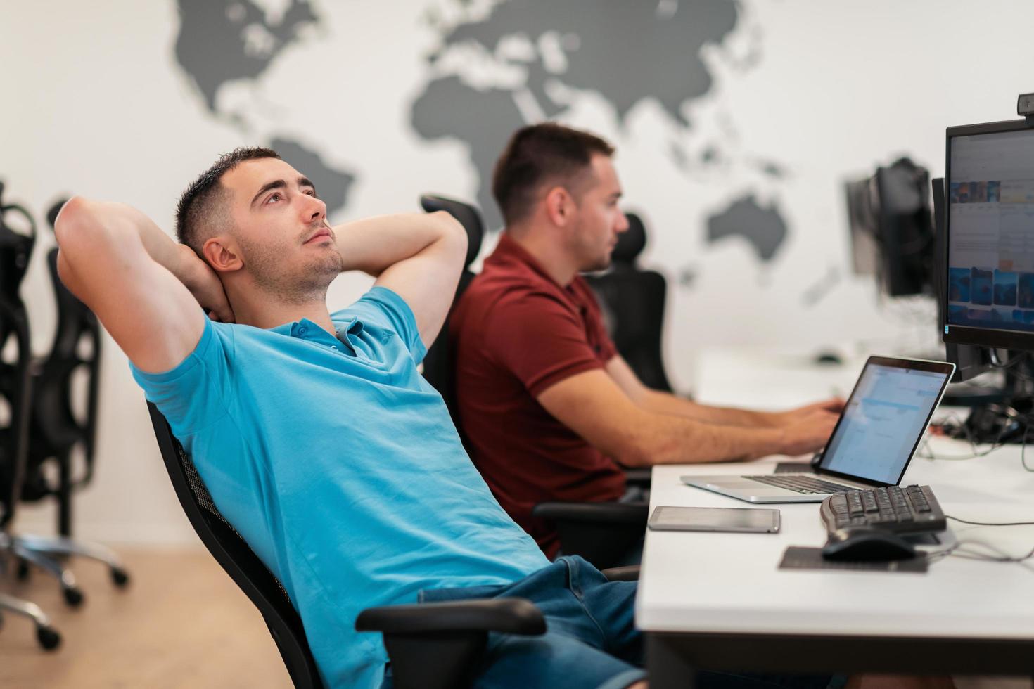 A time for relax. Young tired casual businessman relaxing at the desk in his office. Selective photo