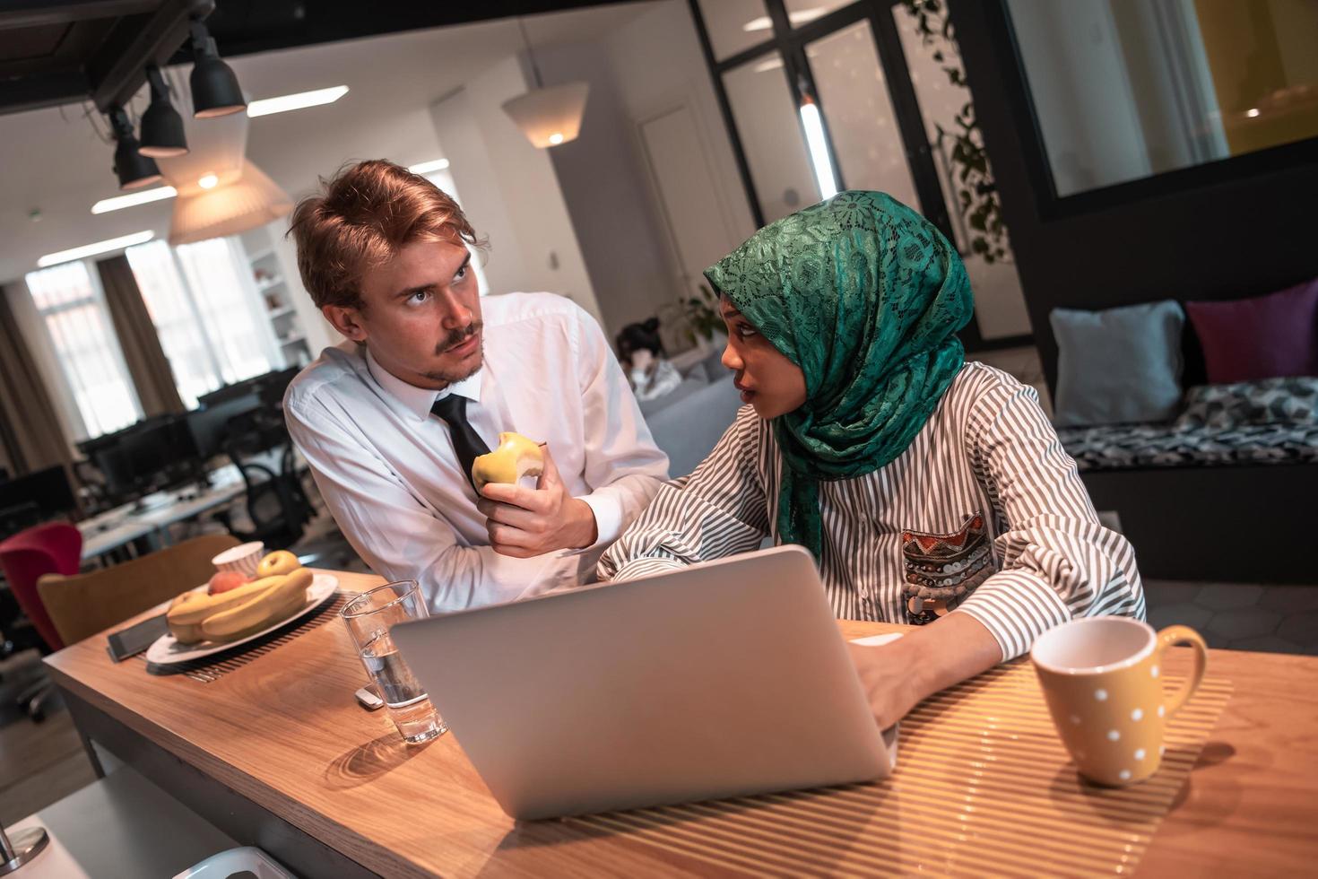 International multicultural business team.A young business man and woman sit in a modern relaxation space and talk about a new business. photo