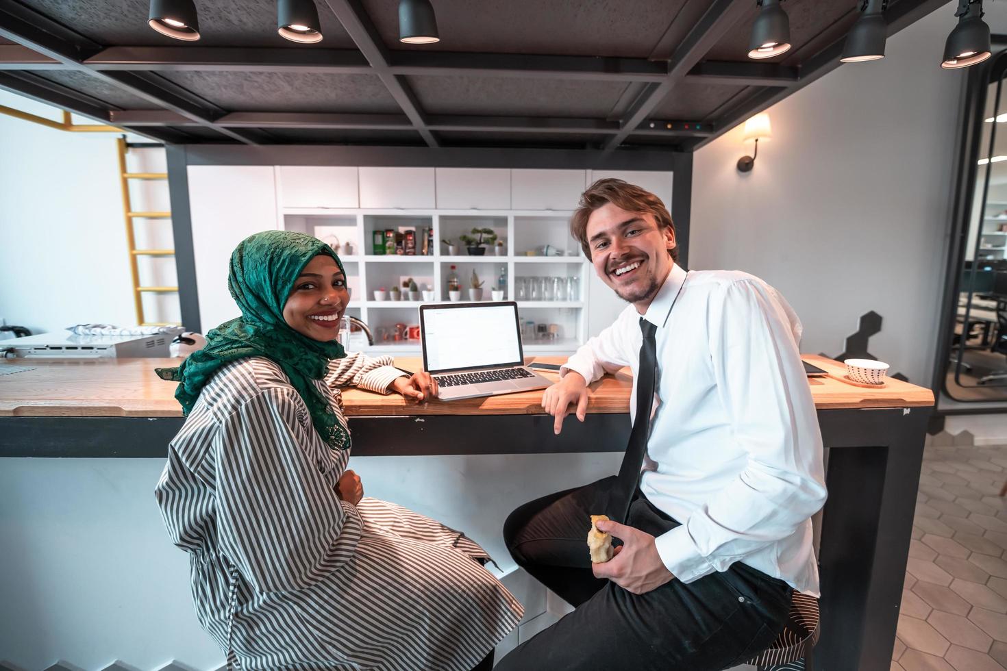 International multicultural business team.A young business man and woman sit in a modern relaxation space and talk about a new business. photo