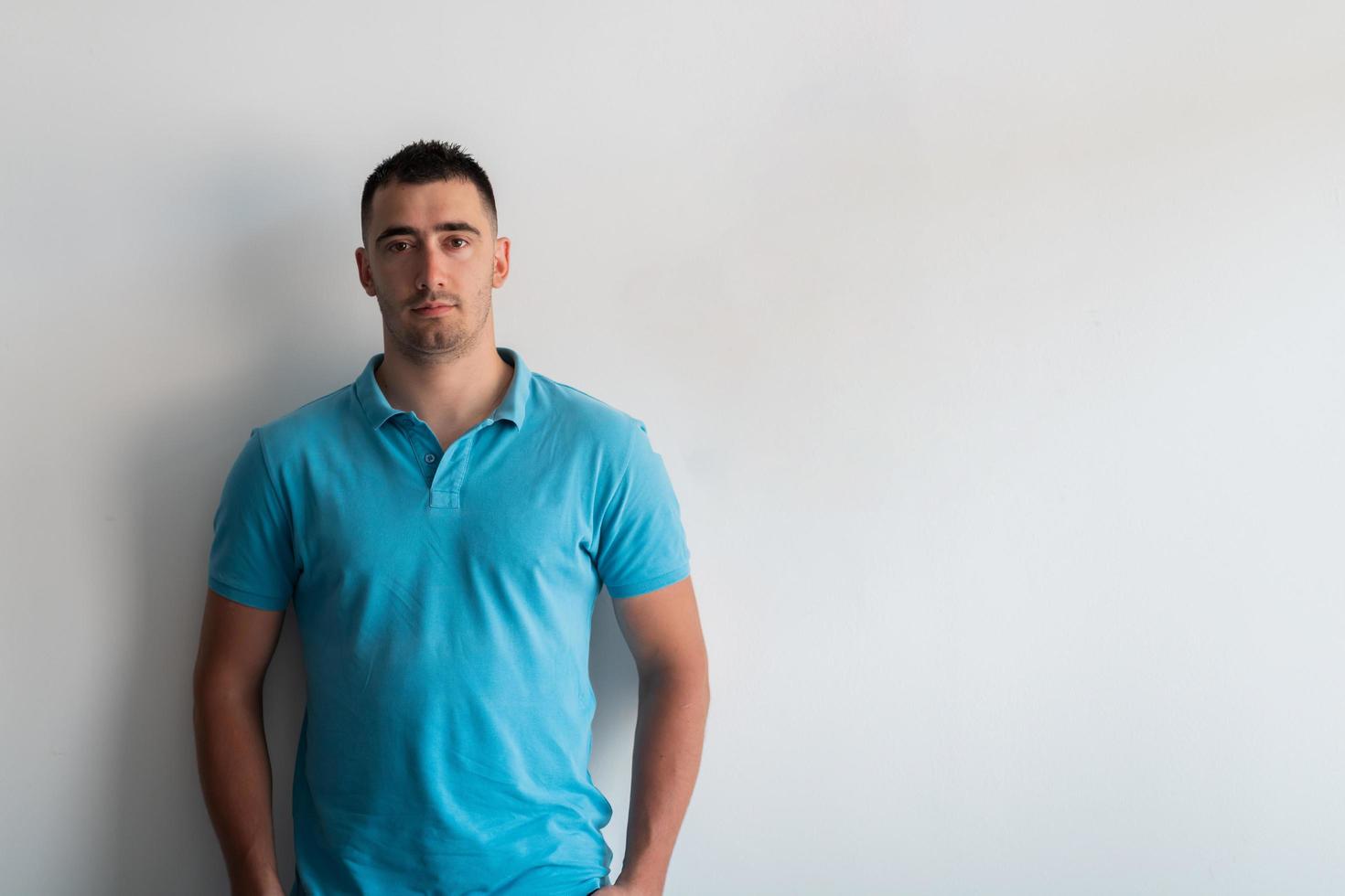 Formal business male portrait. A confident successful casual businessman or manager stands in front of a white background. photo