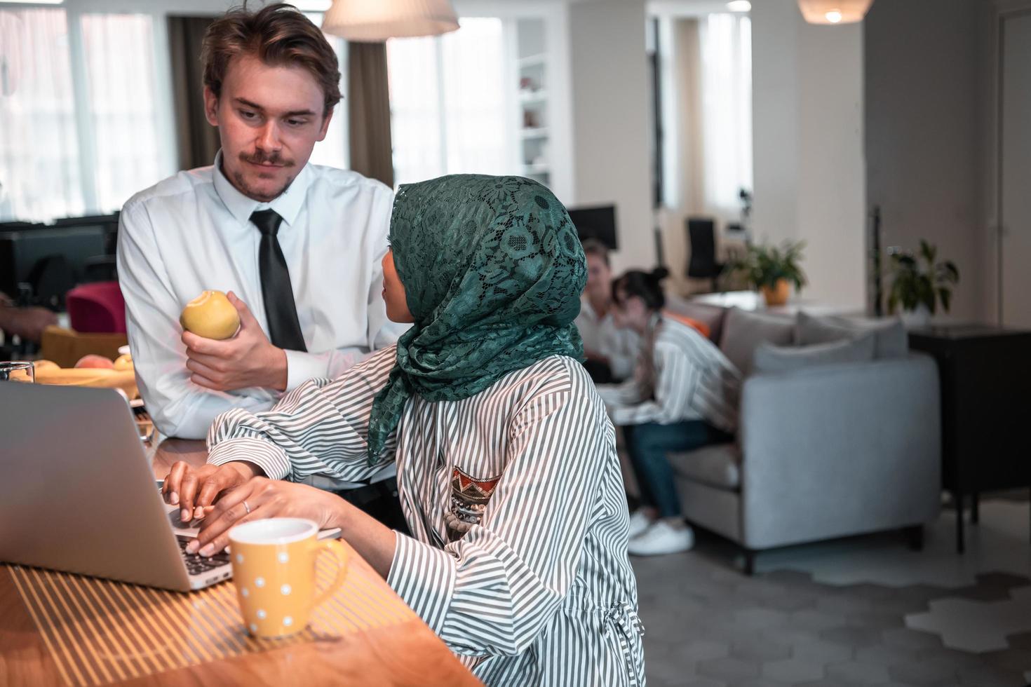 International multicultural business team.A young business man and woman sit in a modern relaxation space and talk about a new business. photo