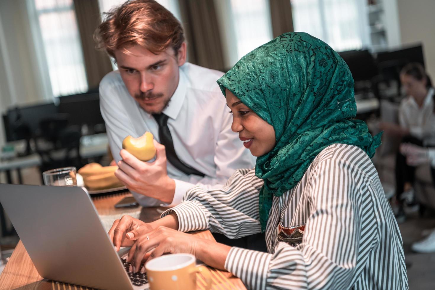 International multicultural business team.A young business man and woman sit in a modern relaxation space and talk about a new business. photo