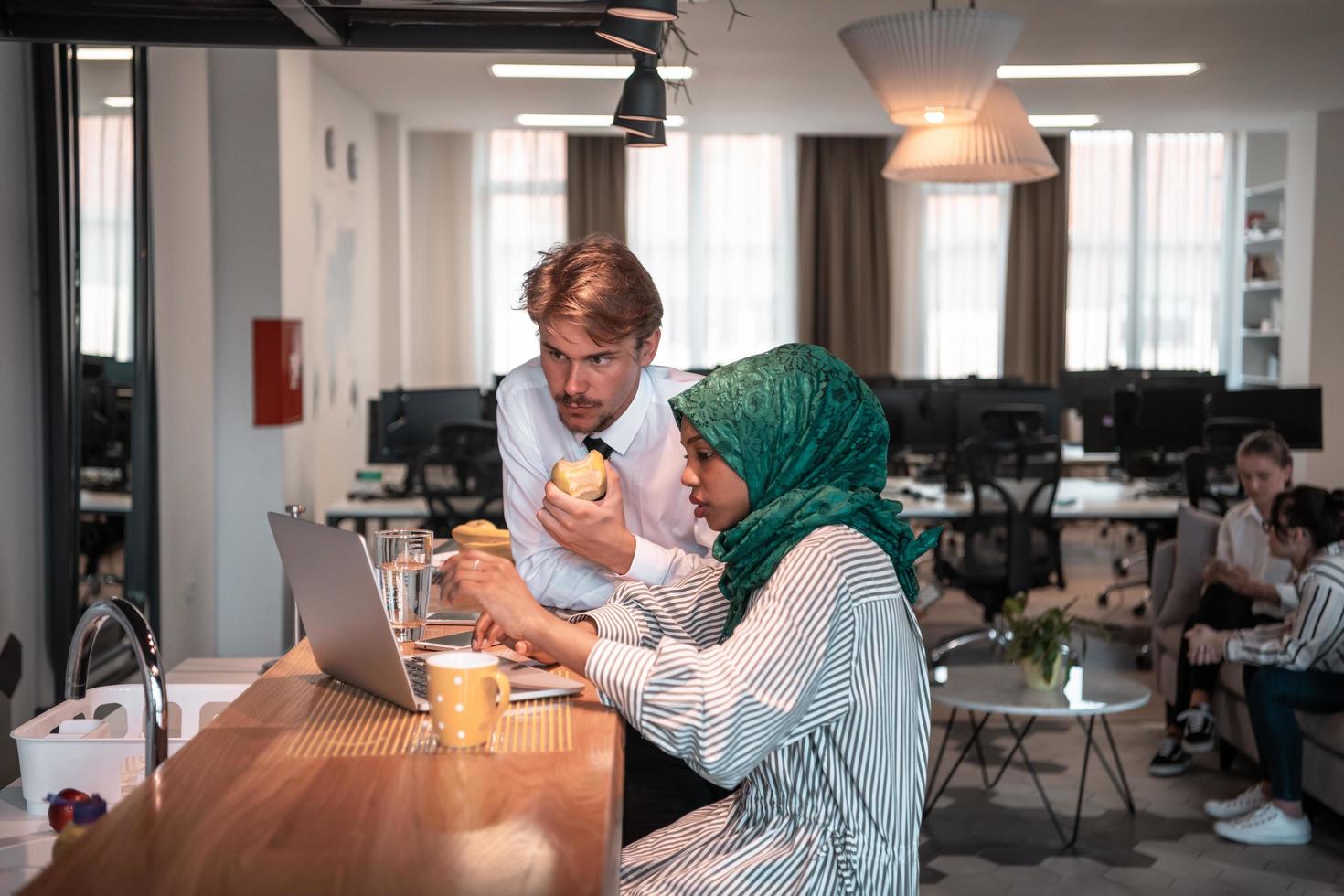 International multicultural business team.A young business man and woman sit in a modern relaxation space and talk about a new business. photo