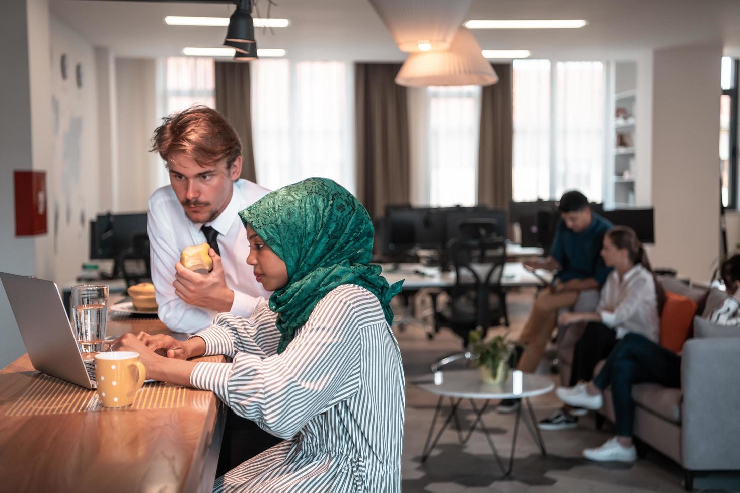 International multicultural business team.A young business man and woman sit in a modern relaxation space and talk about a new business. photo