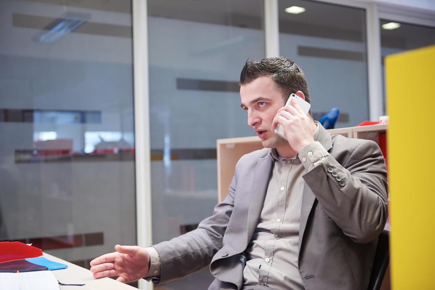 business man talking by phone in office photo