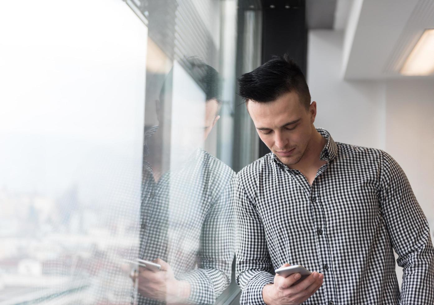young business man using smart phone at office photo