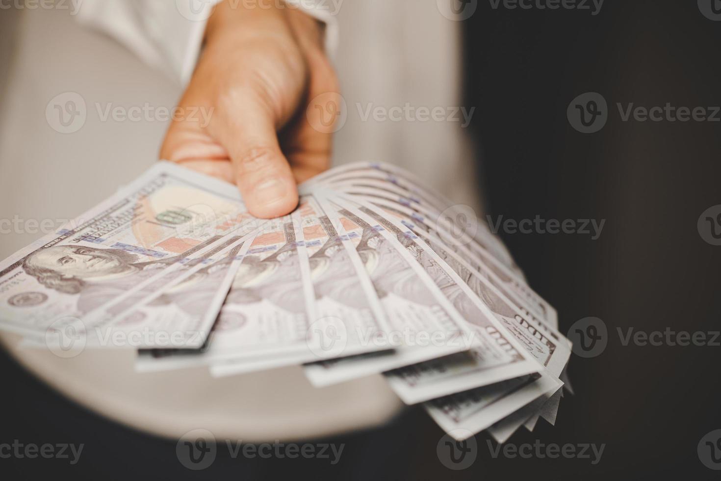 Banknote of 100 dollar bills in hands of rich woman person. Success business female holding cash money for investment. concept of saving finance, exchange bank, american currency, salary payment photo