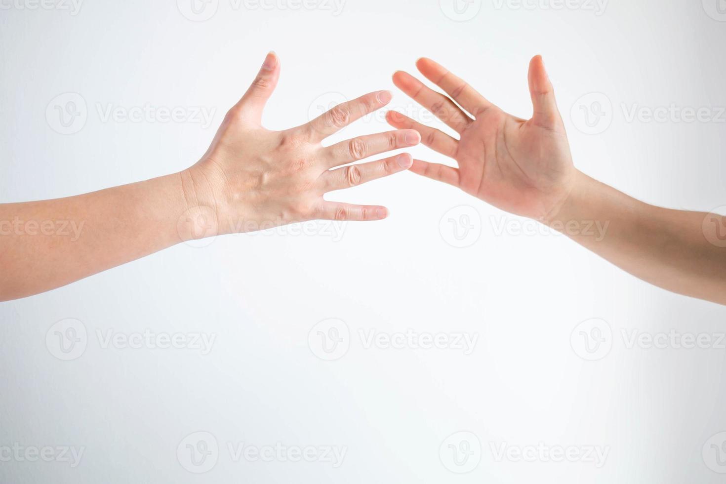 Two teenager slapping hands together for greeting, or player touching hands for replace in sport game. photo