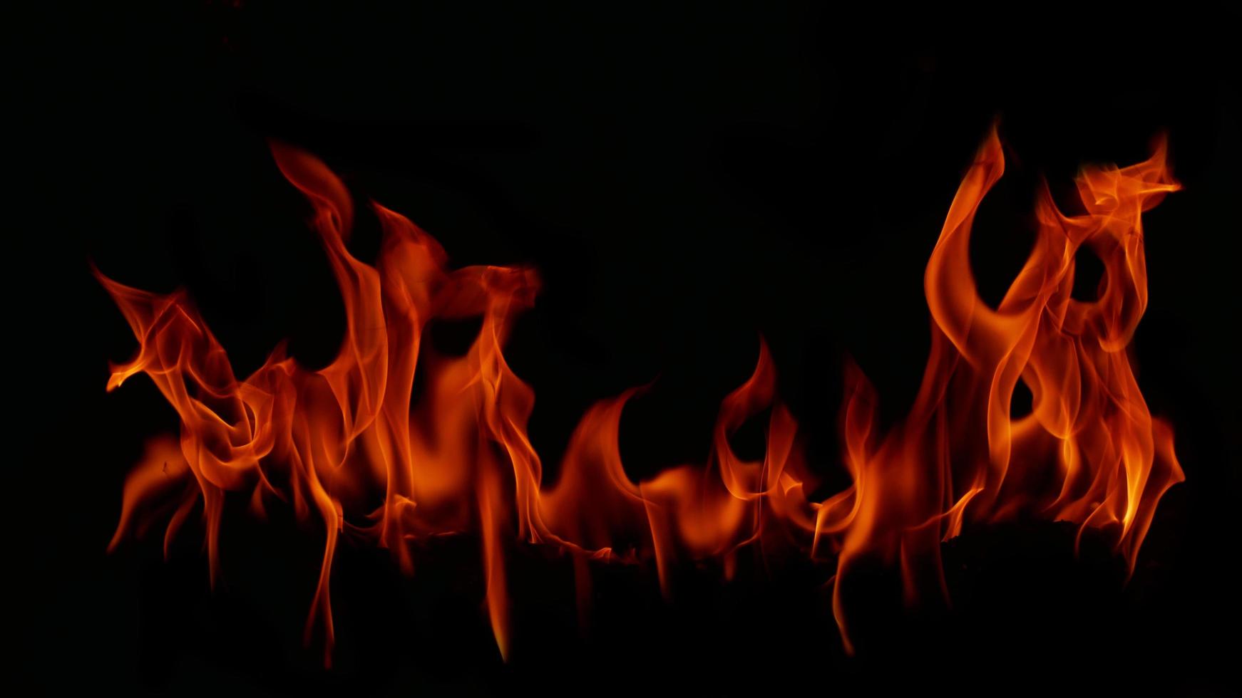 Flame Flame Texture For Strange Shape Fire Background Flame meat that is burned from the stove or from cooking. danger feeling abstract black background Suitable for banners or advertisements. photo