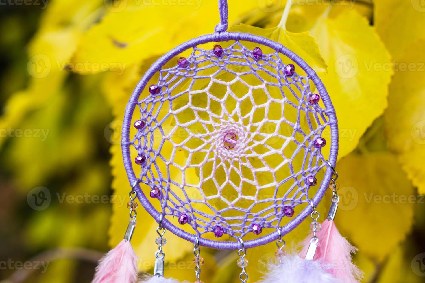 Handmade dream catcher with feathers threads and beads rope hanging photo