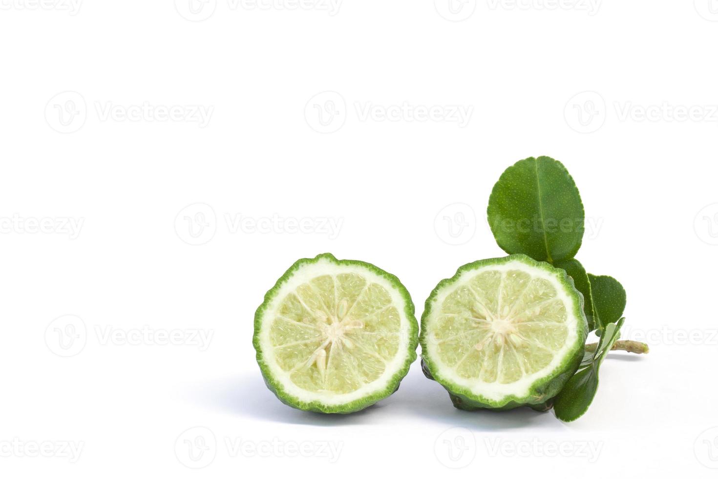 Cut half bergamot, Kaffir lime, Leech lime or Mauritius papeda with leaf is a vegetable and herb of Thailand used as an ingredient in cooking and herbal medicine isolated on white background. photo