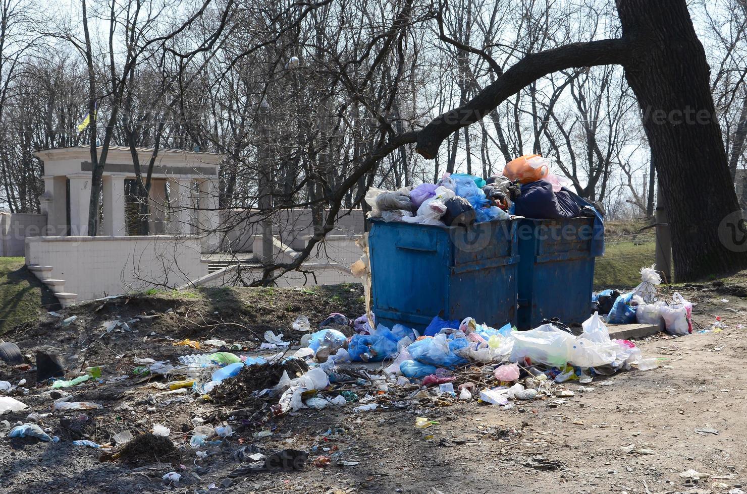 The garbage can is packed with garbage and waste. Untimely removal of garbage in populated areas photo