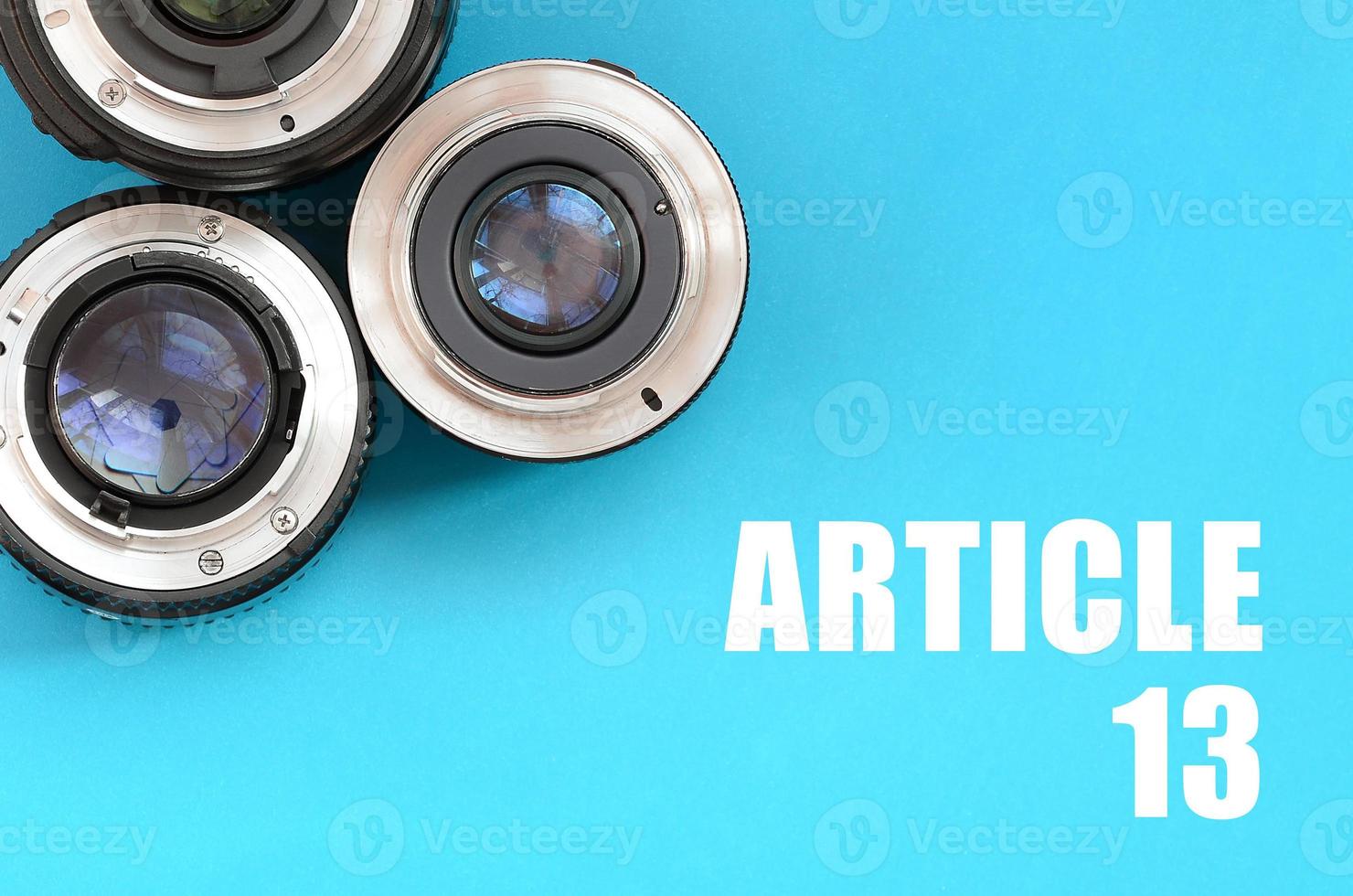 Several photographic lenses and article 13 inscription on blue photo