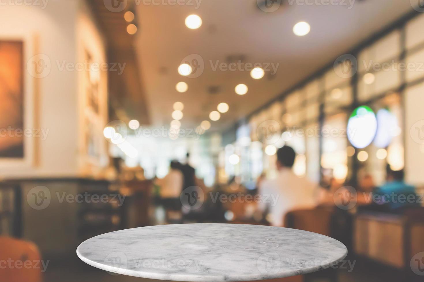 round marble table top with cafe restaurant bokeh lights abstract background for montage product display photo