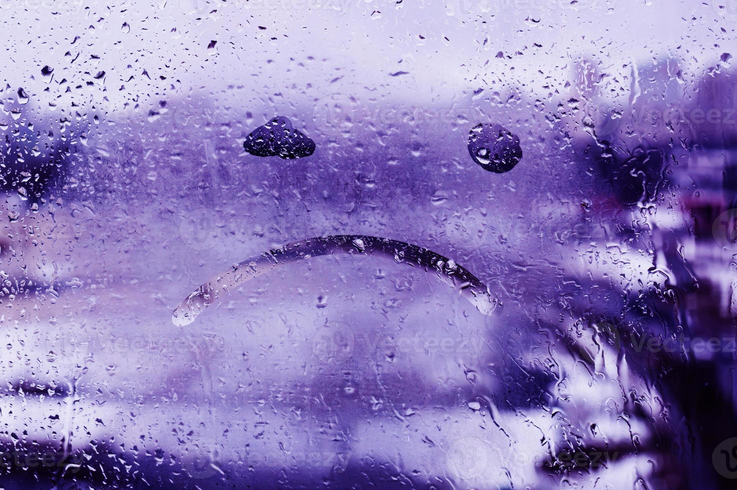 unhappy face drawn on glass photo