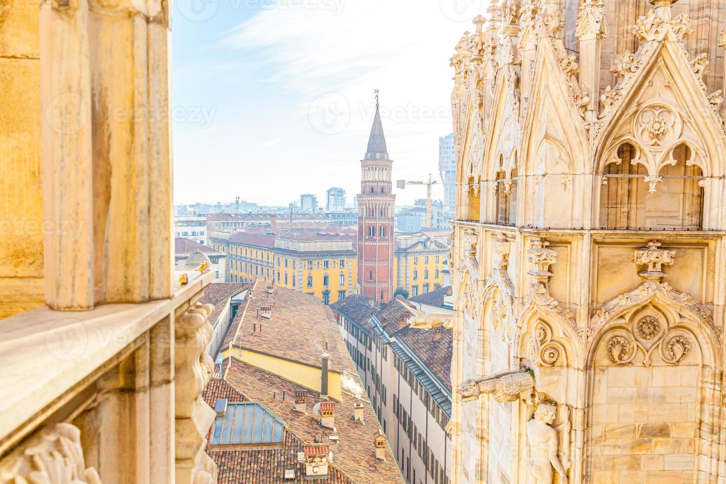 Roof of Milan Cathedral Duomo di Milano with Gothic spires and white marble statues. Top tourist attraction on piazza in Milan, Lombardia, Italy. Wide angle view of old Gothic architecture and art. photo