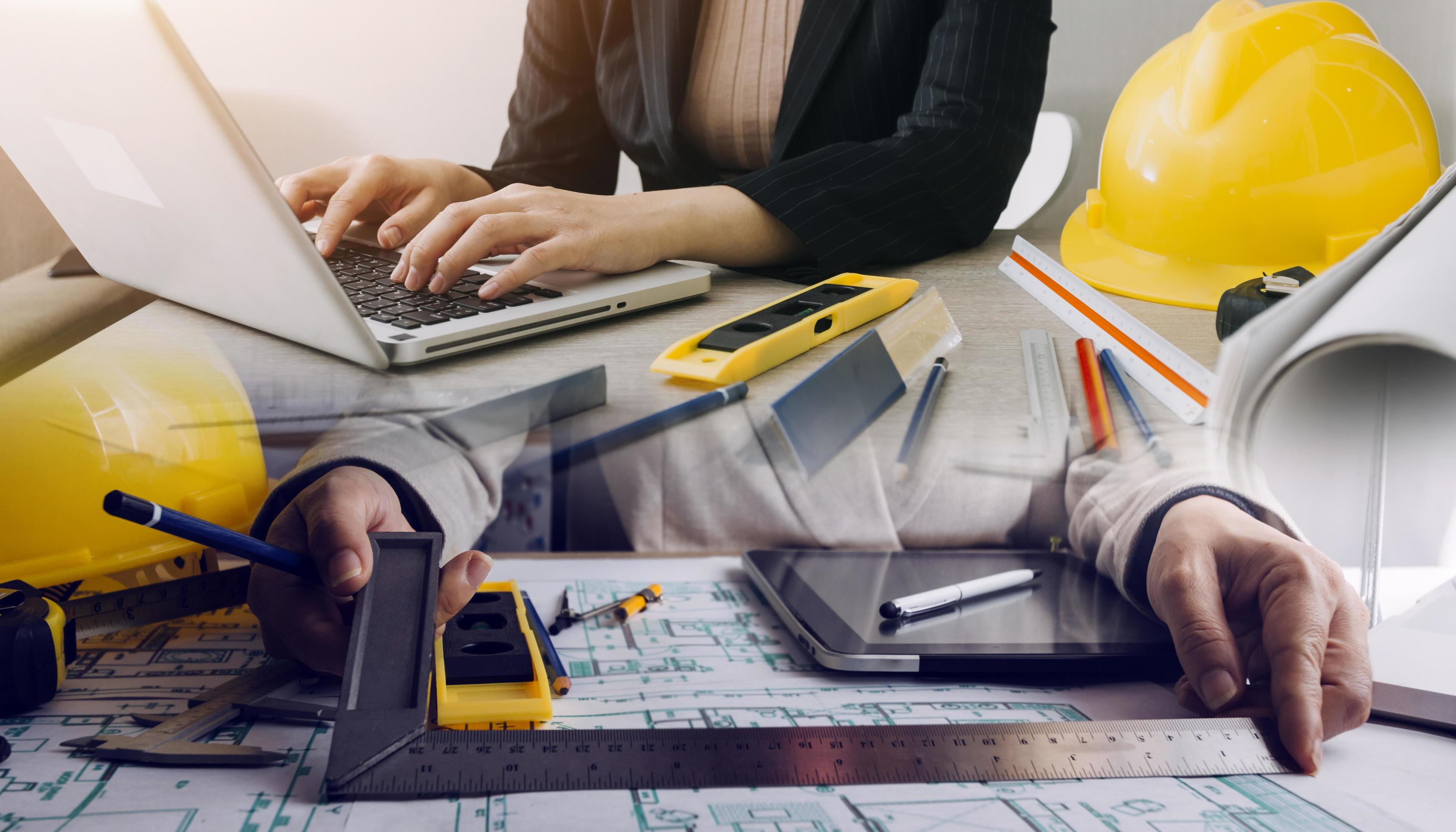 Construction engineer working at blueprint to build large commercial