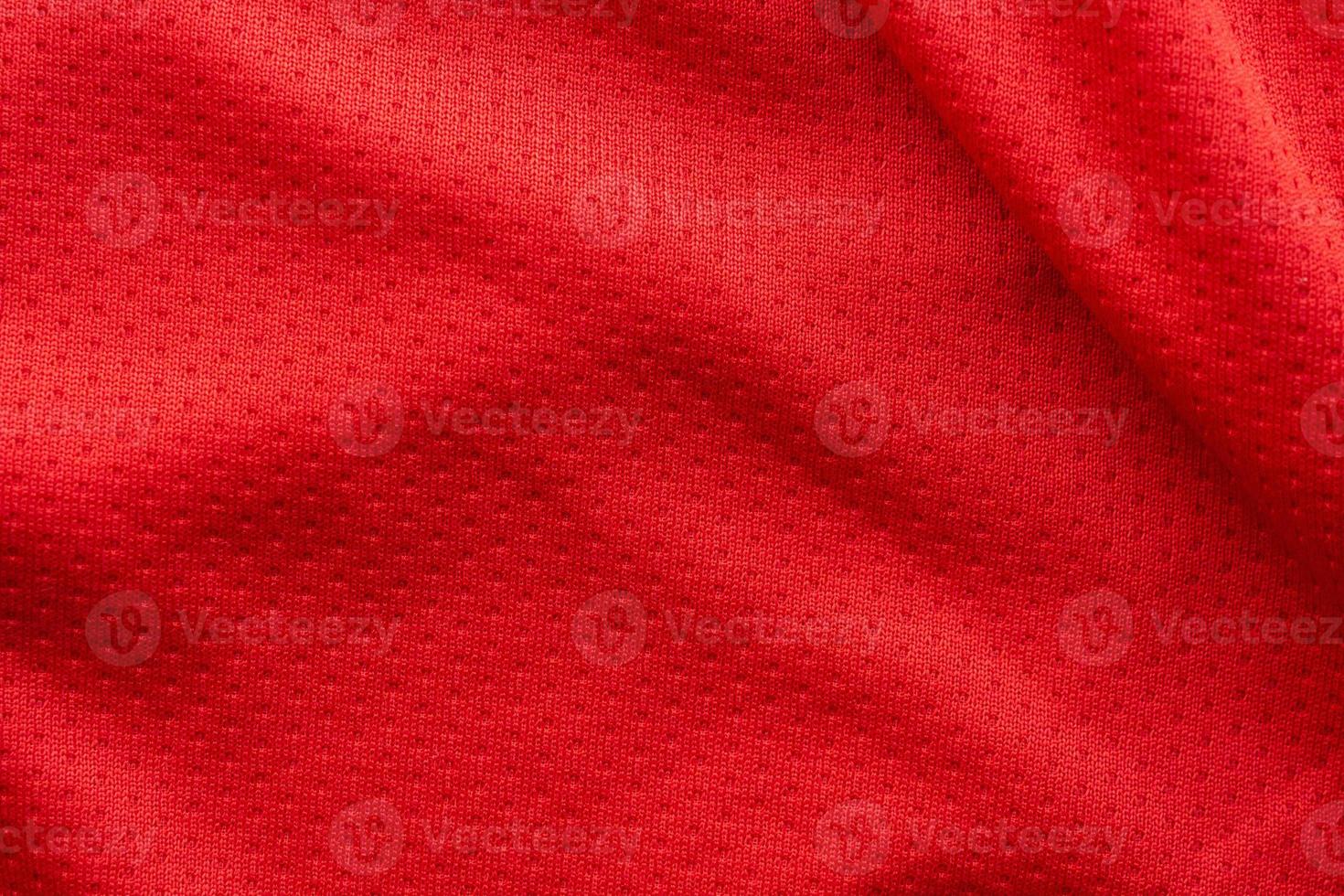 Red fabric sport clothing football jersey with air mesh texture background photo