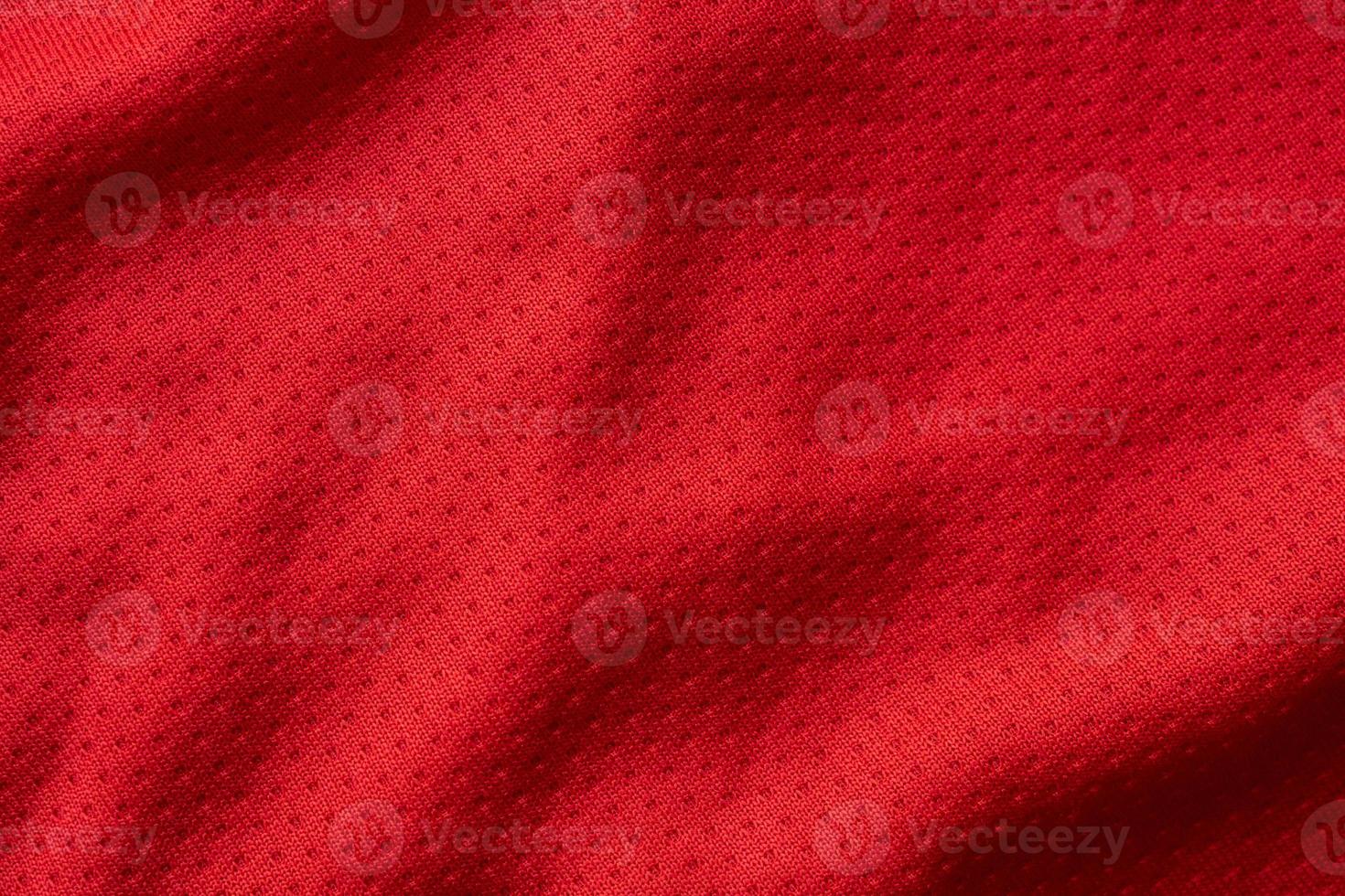 Red fabric sport clothing football jersey with air mesh texture background photo