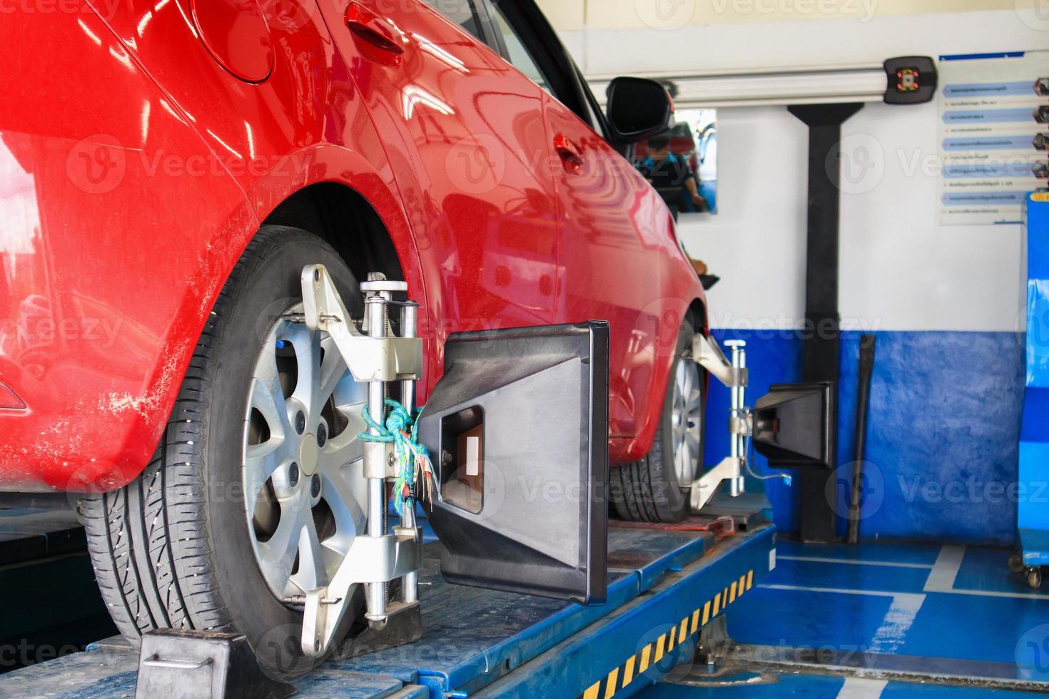Car wheel alignment in progress at auto repair service centre photo
