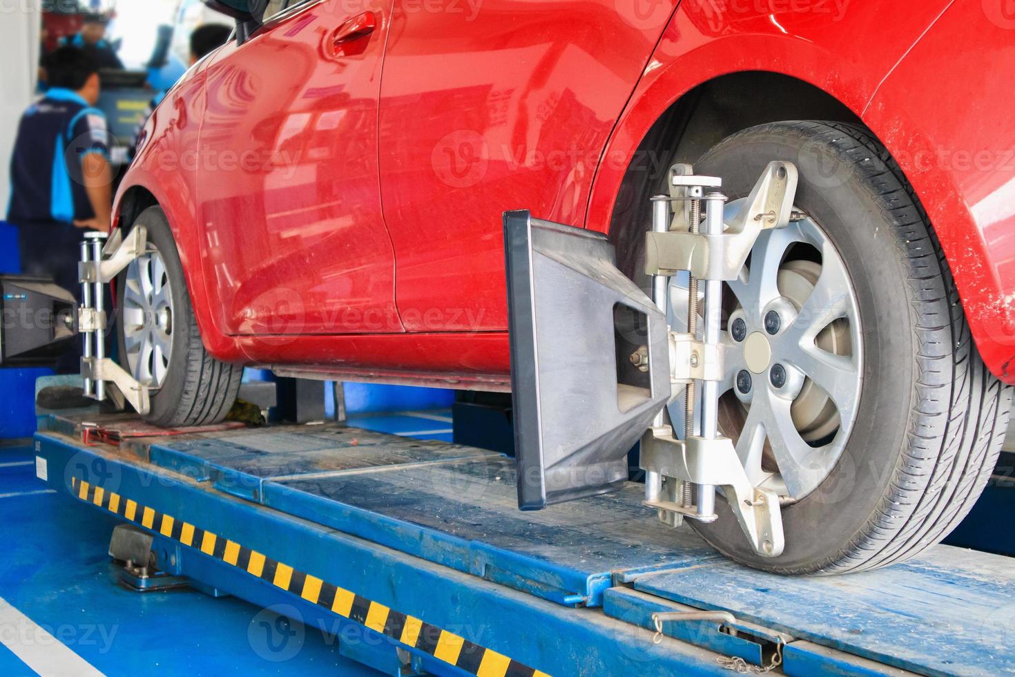 Car wheel alignment in progress at auto repair service centre photo