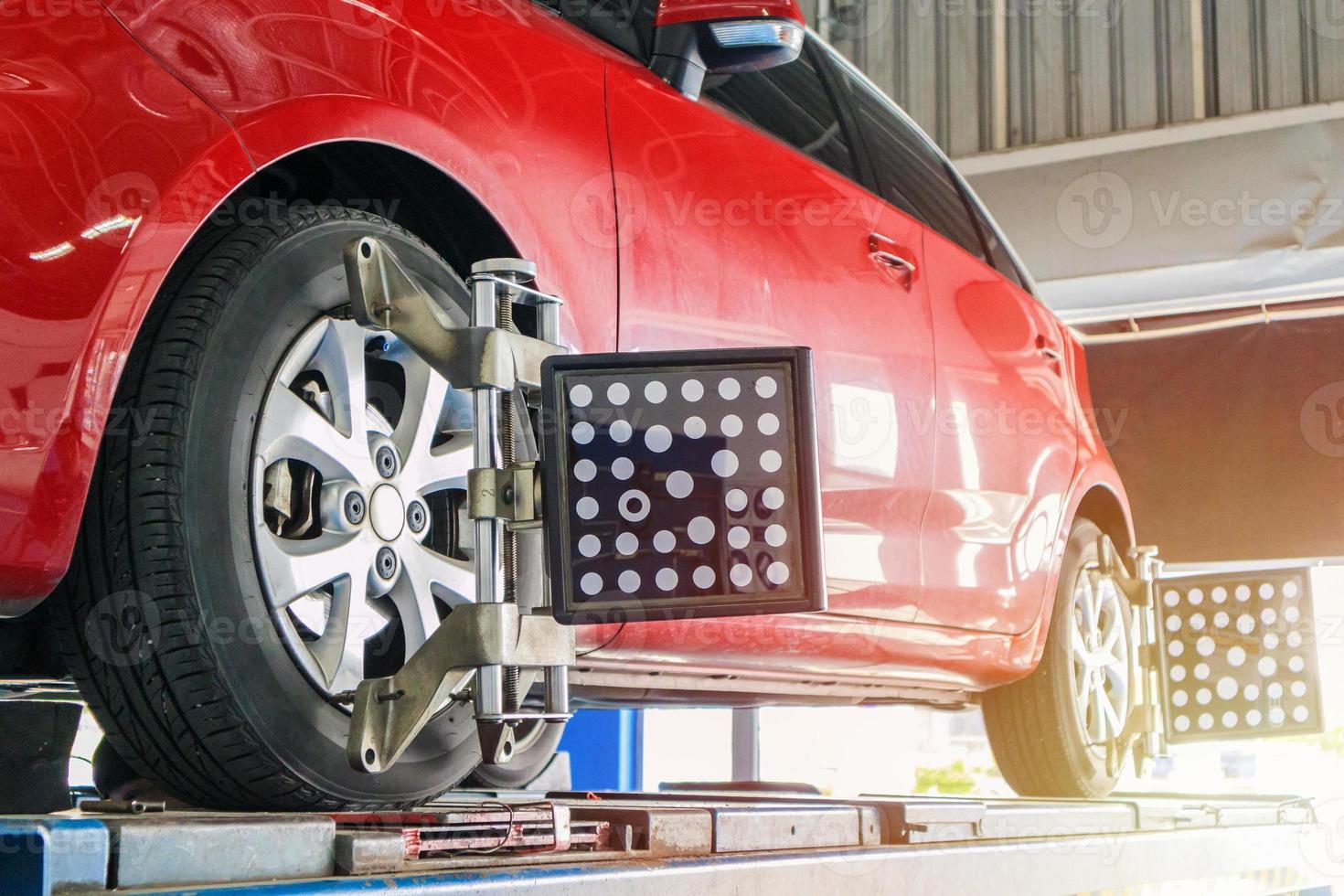 Car wheel alignment in progress at auto repair service centre photo