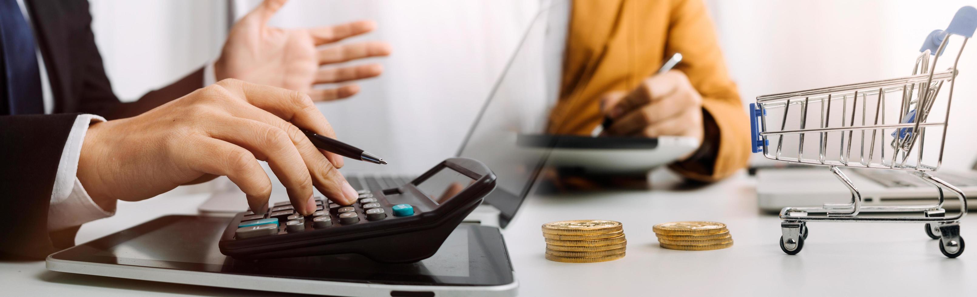 Business accounting concept, Business man using calculator with computer laptop, budget and loan paper in office. photo