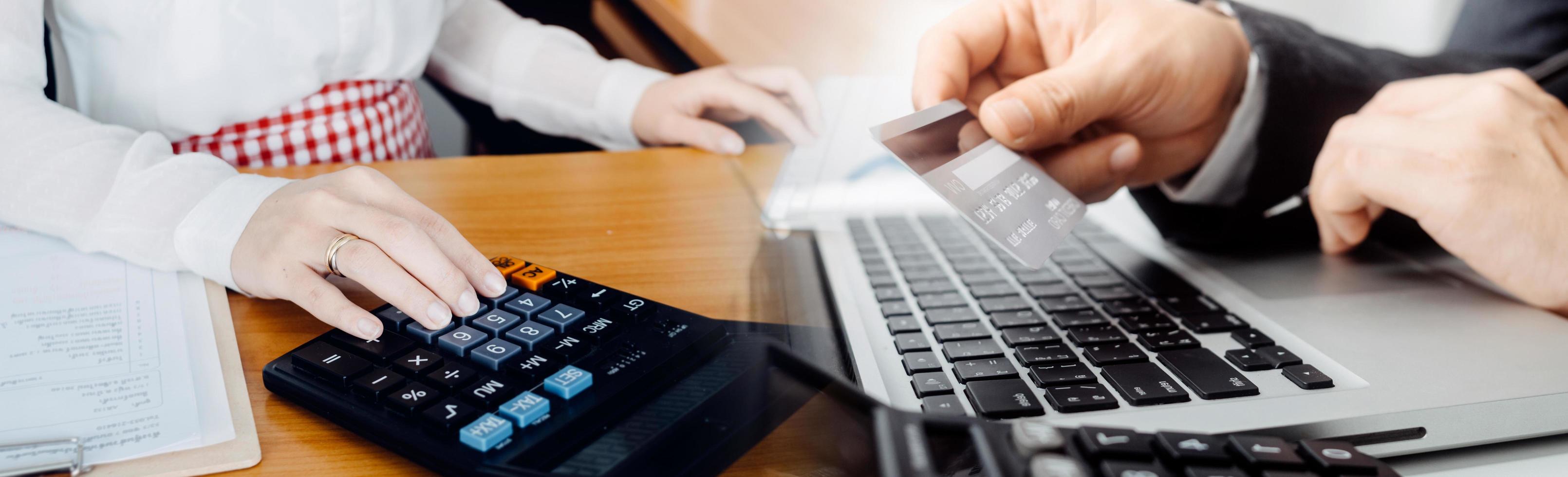 Business accounting concept, Business man using calculator with computer laptop, budget and loan paper in office. photo