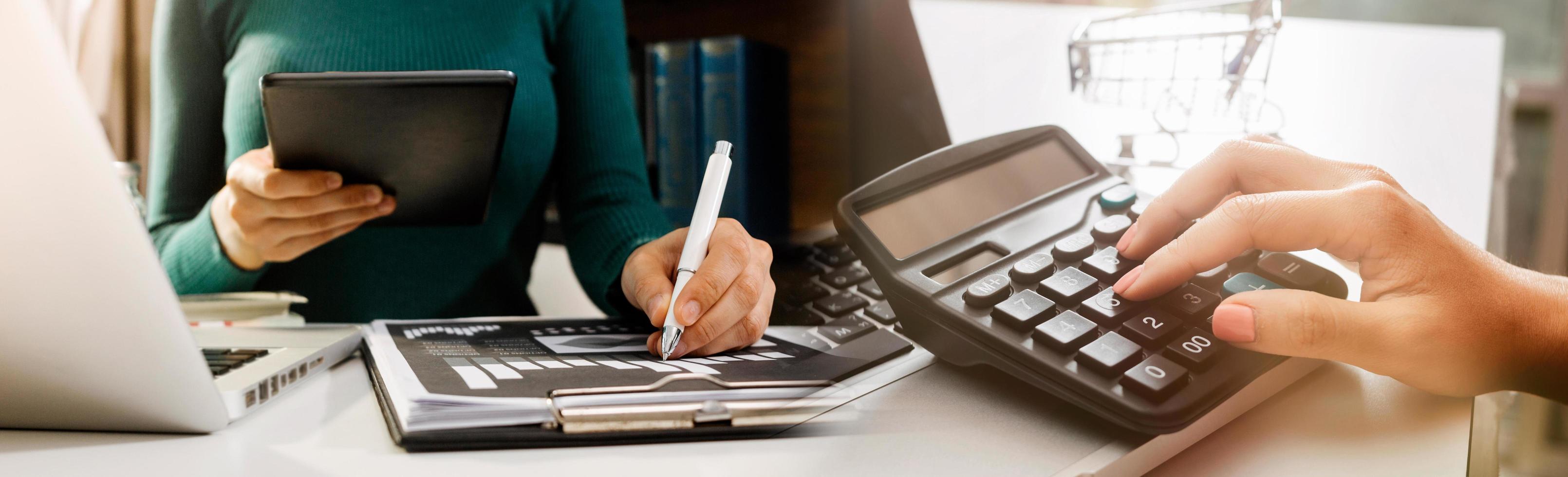 Business accounting concept, Business man using calculator with computer laptop, budget and loan paper in office. photo